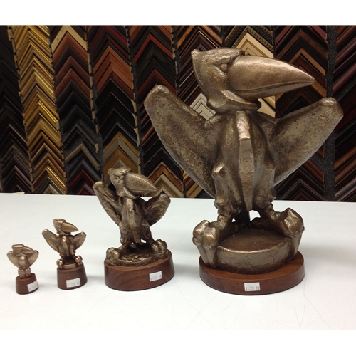 Four Bronze Jayhawk Statues, Each Increasing in Size